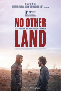 Poster for the movie 'No Other Land', in which we see the two main characters standing towards each other, against the background of the land that is the object of the movie. 